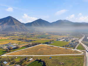 Overview of rural landscape with property boundaries highlighted and a mountain backdrop