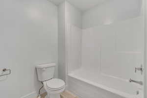 Full bathroom with toilet and shower / tub combination