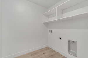 Laundry room featuring washer hookup, light wood-type flooring, and hookup for an electric dryer