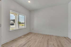 Unfurnished room featuring light wood finished floors and recessed lighting