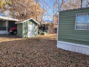 View of yard with a storage unit