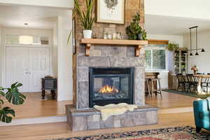 Detailed view of wood finished floors and a fireplace