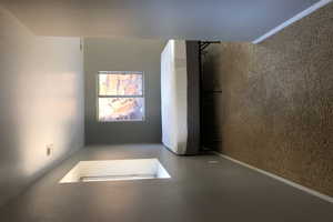 Unfurnished room featuring a textured wall