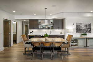 Dining space featuring recessed lighting, dark wood finished floors, and wine cooler