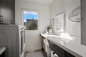 Laundry room with cabinet space and washing machine and clothes dryer