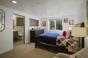 Bedroom featuring light colored carpet, recessed lighting, and connected bathroom