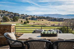 Wooden terrace with outdoor dining space, an outdoor hangout area, a residential view, and a mountain view