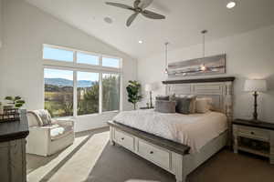 Carpeted bedroom featuring a mountain view, a ceiling fan, recessed lighting, and high vaulted ceiling