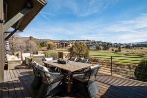 Wooden terrace with outdoor dining area, a mountain view, outdoor lounge area, and a residential view