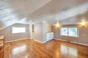 bedroom with light wood-type flooring, lofted ceiling, and recessed lighting