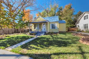 Bungalow-style house featuring covered porch and a metal roof