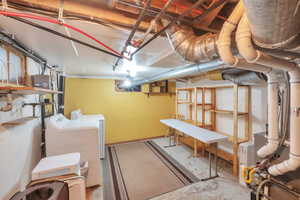 Unfinished below grade area featuring independent washer and dryer