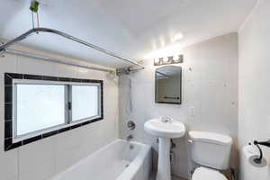 Full bathroom featuring  shower combination and tile walls