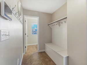 Mudroom featuring baseboards and light tile patterned flooring