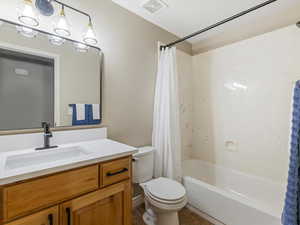 Full bath with shower / bathtub combination with curtain, vanity, and tile patterned floors