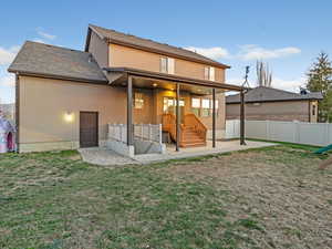 Rear view of house with a patio area, a fenced backyard, stucco siding, and a shingled roof