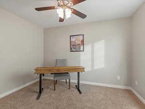 Office featuring light colored carpet and ceiling fan