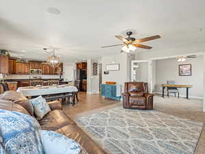 Living area with a chandelier, a ceiling fan, and recessed lighting