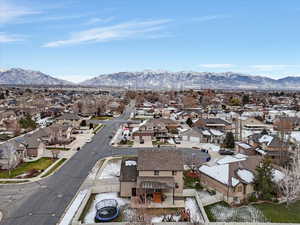 Aerial perspective of suburban area featuring a mountain backdrop