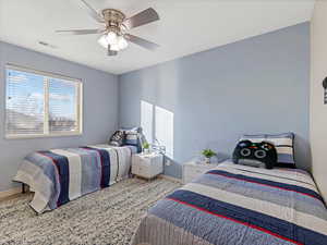 Bedroom featuring ceiling fan and baseboards