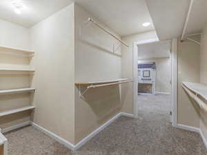Spacious closet with light colored carpet
