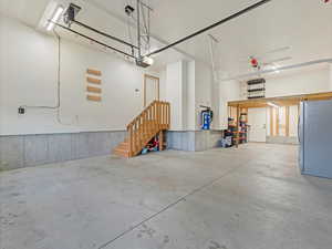 Garage with freestanding refrigerator and a garage door opener