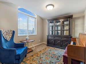 Sitting room featuring baseboards and light colored carpet