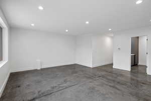 Spare room with concrete floors and recessed lighting