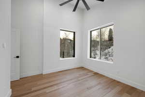 Empty room featuring light wood-style floors and a ceiling fan