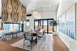 Dining room featuring recessed lighting, wood finished floors, a multi sided fireplace, and a chandelier