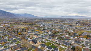 Aerial view of property's location with nearby suburban area and mountains