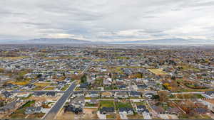 Aerial overview of property's location with nearby suburban area and mountains