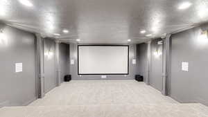 Cinema room with light colored carpet, recessed lighting.