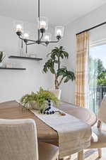 Dining area featuring a chandelier and wood finished floors