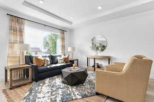 Living room featuring light wood-style flooring and recessed lighting