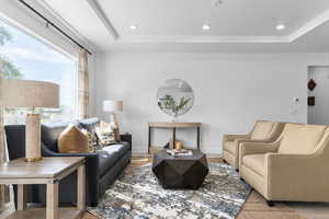 Living room with a tray ceiling and recessed lighting