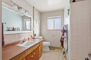 Full bathroom featuring vanity and light tile patterned floors