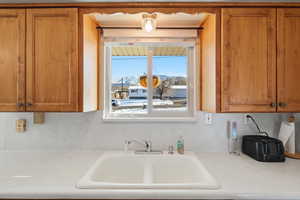 Kitchen with brown cabinetry and light countertops