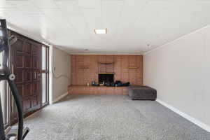 Unfurnished living room with carpet flooring and baseboards