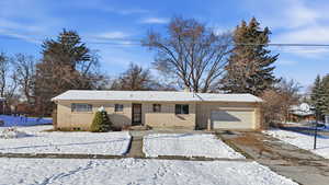 Ranch-style home with brick siding, a garage, and concrete driveway