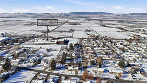 Snowy aerial view featuring a mountain view