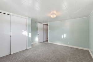 Unfurnished bedroom featuring carpet flooring and a closet