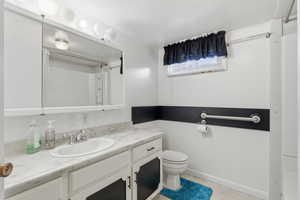 Full bath with vanity and a shower with shower curtain