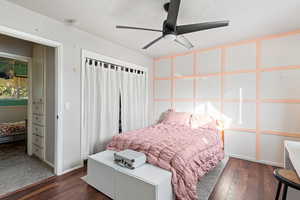 Bedroom featuring dark wood-type flooring and a ceiling fan