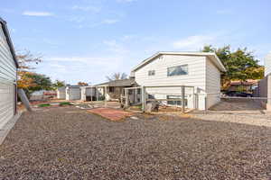Rear view of property with a fenced backyard, a patio area, and a gate