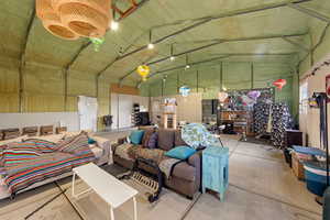 Living area featuring high vaulted ceiling