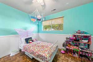 Bedroom featuring wainscoting