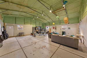 Misc room featuring high vaulted ceiling and a garage