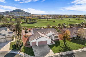 View from above of property featuring a mountain backdrop and a local golf course