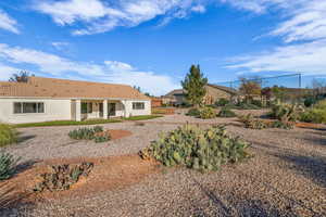 Back of house featuring a patio, stucco siding, and a tiled roof